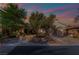 Charming home showcasing professionally landscaped front yard, with three-car garage, and inviting entrance at 5 Circa De Montanas, Henderson, NV 89011