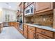 Kitchen with stainless steel appliances, mosaic backsplash, and natural wood cabinetry at 5 Circa De Montanas, Henderson, NV 89011