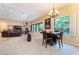 Open concept living area with dining space, stone fireplace and backyard views at 5 Circa De Montanas, Henderson, NV 89011
