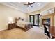 Spacious main bedroom with a tray ceiling, fireplace and access to the backyard at 5 Circa De Montanas, Henderson, NV 89011