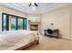 Light-filled main bedroom featuring a fireplace, tray ceiling and doors to the backyard at 5 Circa De Montanas, Henderson, NV 89011