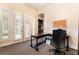 Office space with french doors, a dark wood desk and cabinet, plus patterned carpeting at 5 Circa De Montanas, Henderson, NV 89011