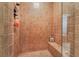 Tiled shower showcasing neutral tilework, a built-in bench, and clear glass doors at 5 Circa De Montanas, Henderson, NV 89011
