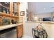 Charming wet bar area with sink, mini fridge and custom cabinetry at 5 Circa De Montanas, Henderson, NV 89011
