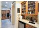 Charming wet bar area with sink, mini fridge and custom cabinetry at 5 Circa De Montanas, Henderson, NV 89011