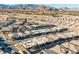 An aerial view of a residential development with modern homes and scenic mountain views at 5030 Sandline Court, Las Vegas, NV 89135