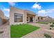 Exterior backyard with patio, lawn and desert landscaping at 5030 Sandline Court, Las Vegas, NV 89135