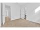 Bright bedroom with tan carpet flooring and white walls at 5030 Sandline Court, Las Vegas, NV 89135
