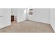 Bright bedroom with tan carpet flooring and a window at 5030 Sandline Court, Las Vegas, NV 89135