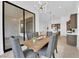 Bright dining area featuring a modern light fixture and sliding doors leading to the backyard patio at 5030 Sandline Court, Las Vegas, NV 89135