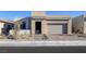 Beautiful single-story home with stone accents, neutral color palette, desert landscaping and brick paved driveway at 5030 Sandline Court, Las Vegas, NV 89135