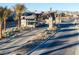 A manned security gate with desert landscaping and palm trees at 5030 Sandline Court, Las Vegas, NV 89135
