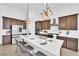 Contemporary kitchen with quartz countertops, stainless steel appliances, and an island with barstool seating at 5030 Sandline Court, Las Vegas, NV 89135
