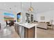Open concept kitchen with quartz countertops, stainless steel appliances, and seamless flow to the living area at 5030 Sandline Court, Las Vegas, NV 89135