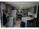 Functional kitchen with stainless steel appliances, ample counter space, and tile flooring at 516 Sellers Pl, Henderson, NV 89011