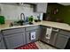 This kitchen features stainless steel appliances, light gray cabinets, and an undermounted double sink at 516 Sellers Pl, Henderson, NV 89011