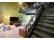 Living area with tiled floors, a balcony feature, stairs, and comfortable seating at 516 Sellers Pl, Henderson, NV 89011