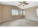 Spacious bedroom with ample natural light from multiple windows and a ceiling fan at 5245 Sand Dollar Ave, Las Vegas, NV 89141