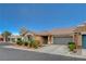 This one-story home boasts a well-kept lawn and a convenient attached two-car garage at 5245 Sand Dollar Ave, Las Vegas, NV 89141