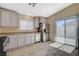 Well-lit kitchen with white cabinets, stainless steel appliances, and sliding door access to outside at 5245 Sand Dollar Ave, Las Vegas, NV 89141