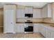 This kitchen features stainless steel appliances, light gray cabinets, and tile flooring at 5245 Sand Dollar Ave, Las Vegas, NV 89141