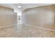 Airy living room boasts tile floors, vaulted ceilings, and access to an adjacent kitchen at 5245 Sand Dollar Ave, Las Vegas, NV 89141