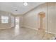 Light and airy living room features tile floors, vaulted ceilings, and a neutral color palette at 5245 Sand Dollar Ave, Las Vegas, NV 89141