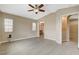 A spacious main bedroom with ceiling fan, connecting bathroom, and a ceramic tile floor at 5245 Sand Dollar Ave, Las Vegas, NV 89141