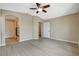Spacious main bedroom with ceiling fan, arched doorways, and a ceramic tile floor at 5245 Sand Dollar Ave, Las Vegas, NV 89141