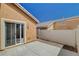 Concrete patio with sliding glass door and privacy fence, ideal for outdoor living at 5245 Sand Dollar Ave, Las Vegas, NV 89141