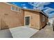 Exterior patio with siding doors, neutral stucco and concrete floor at 5245 Sand Dollar Ave, Las Vegas, NV 89141