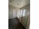 Bathroom featuring a soaking tub with glass shower door, and dark wood flooring at 5937 Armide St, North Las Vegas, NV 89081
