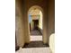 View of home's front door through an arched entryway with paved brick walkway at 5937 Armide St, North Las Vegas, NV 89081