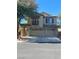 Charming two-story home with a three-car garage, decorative shutters, and a small balcony on the second story at 5937 Armide St, North Las Vegas, NV 89081
