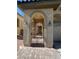 Close up of entry gate with decorative wrought iron and arched entry with lighting fixtures at 5937 Armide St, North Las Vegas, NV 89081