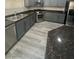 Gray-toned kitchen with granite countertops, stainless appliances and hardware plus ample storage and natural light at 5937 Armide St, North Las Vegas, NV 89081