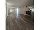 Spacious living room featuring hardwood floors, a fireplace, and natural light from the windows at 5937 Armide St, North Las Vegas, NV 89081