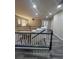 Upstairs loft featuring gray wood-style flooring, modern railing, and a ceiling fan for comfortable living at 5937 Armide St, North Las Vegas, NV 89081