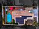 Aerial view featuring this home with solar panels, a pool, spa and covered patio at 6129 Flaming Arrow Rd, North Las Vegas, NV 89031