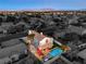 Aerial view of this home that features a pool, spa, covered patio and lush landscaping at 6129 Flaming Arrow Rd, North Las Vegas, NV 89031