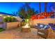 Cozy outdoor space with a fire pit, pizza oven, and comfortable seating area perfect for entertaining at 6129 Flaming Arrow Rd, North Las Vegas, NV 89031