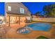Stunning backyard with a refreshing pool, spa, covered patio, and lush landscaping, creating a private oasis at 6129 Flaming Arrow Rd, North Las Vegas, NV 89031