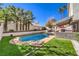 Beautiful backyard featuring a sparkling pool and well-maintained landscaping at 6129 Flaming Arrow Rd, North Las Vegas, NV 89031