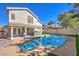 Attractive backyard with a pool, spa and covered patio with an outdoor kitchen at 6129 Flaming Arrow Rd, North Las Vegas, NV 89031