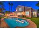 Spacious backyard with a refreshing pool and spa, complemented by a covered patio and outdoor kitchen at 6129 Flaming Arrow Rd, North Las Vegas, NV 89031