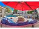 Cozy outdoor seating area around a fire pit next to the pool at 6129 Flaming Arrow Rd, North Las Vegas, NV 89031