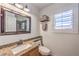 Bright bathroom with granite counters, decorative mirror, and neutral finishes at 6129 Flaming Arrow Rd, North Las Vegas, NV 89031