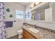 Bright bathroom featuring granite counters, vanity, and modern fixtures at 6129 Flaming Arrow Rd, North Las Vegas, NV 89031