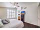 Well-lit bedroom with wood floors, plantation shutters, and stylishly coordinated furnishings at 6129 Flaming Arrow Rd, North Las Vegas, NV 89031