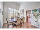 Dining room featuring a chandelier, shuttered windows, and views of the open kitchen at 6129 Flaming Arrow Rd, North Las Vegas, NV 89031